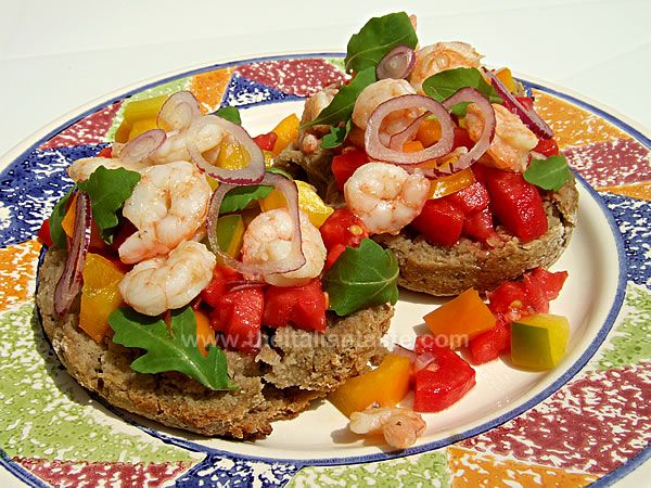 Friselle topped with prawns, peppers, tomatoes